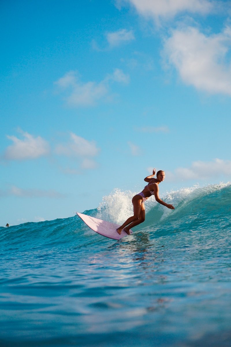 man in black shorts surfing on sea during daytime